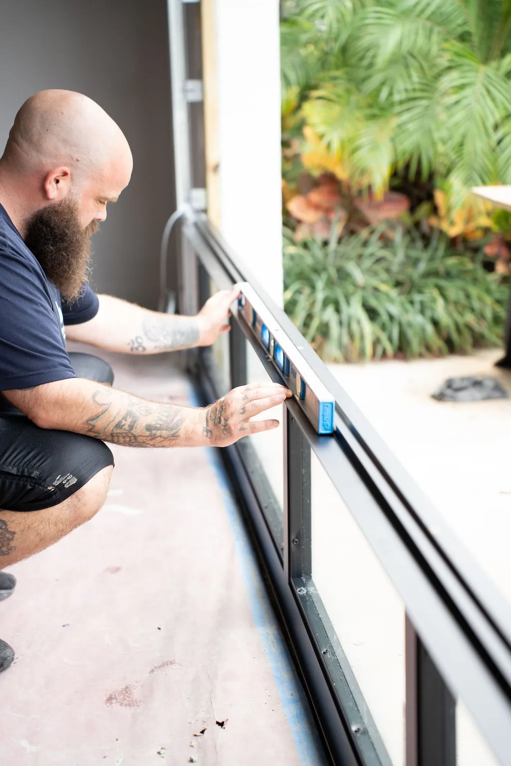 Lift Kings technician using a level to align a freshly installed garage door